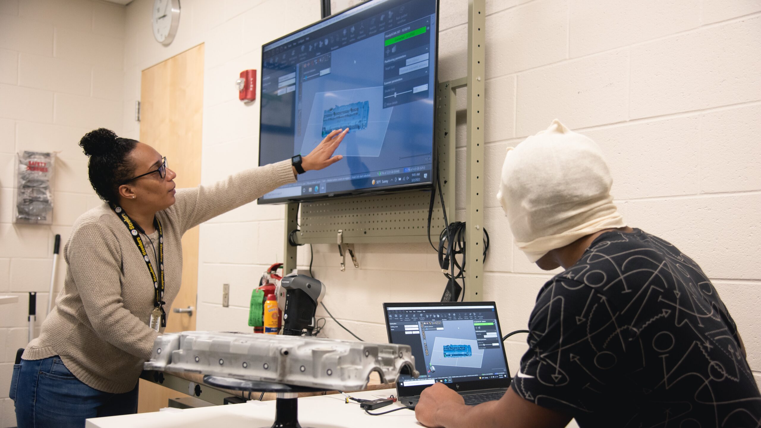 Instructor Natasha Diaz guides a student on how to use 3D scanner software in the Ray Bagley Innovation Lab at The Newport News Shipbuilding Apprentice School. (Photo by Ashley Cowan/HII)